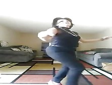 Jeans-Clad Arab Woman Dancing In Her Living Room