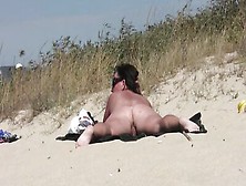 Naked Brunette Is Secretly Filmed While Sunbathing On The Beach