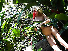 Blonde Girl Gets Naked And Poses Sexily With The Plants Outside.